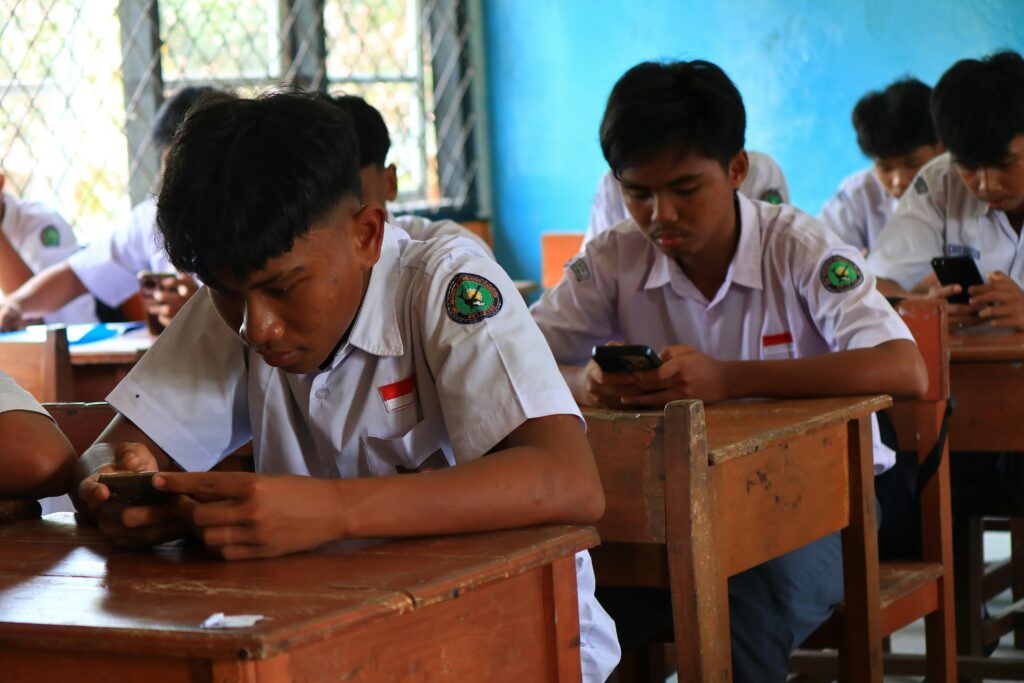 Students using smartphones as part of a classroom activity